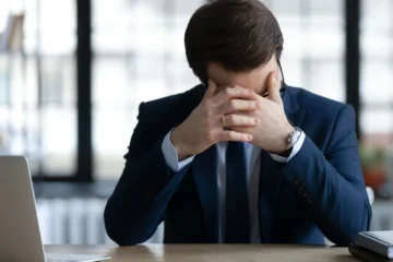 Business owner reviewing financial records after a bookkeeper quit